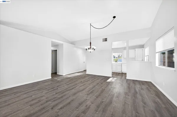 a view of a room with wooden floor and white walls