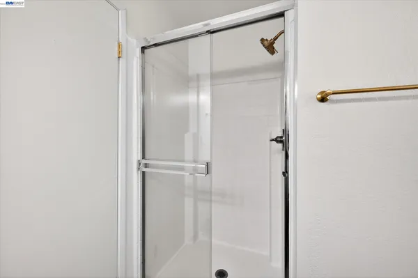 a bathroom with a glass shower door
