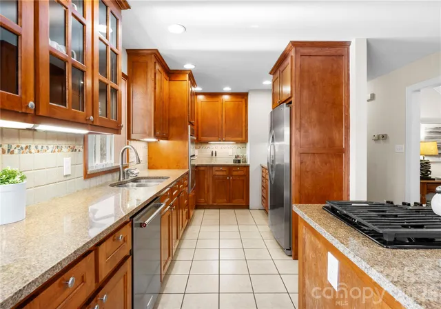 a dining room with wooden floor a chandelier a wooden table and chairs