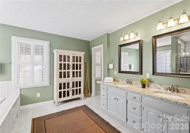 a white bath tub sitting in a bathroom next to a window
