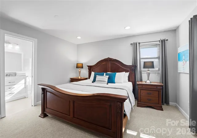 a bathroom with a granite countertop sink a toilet and shower
