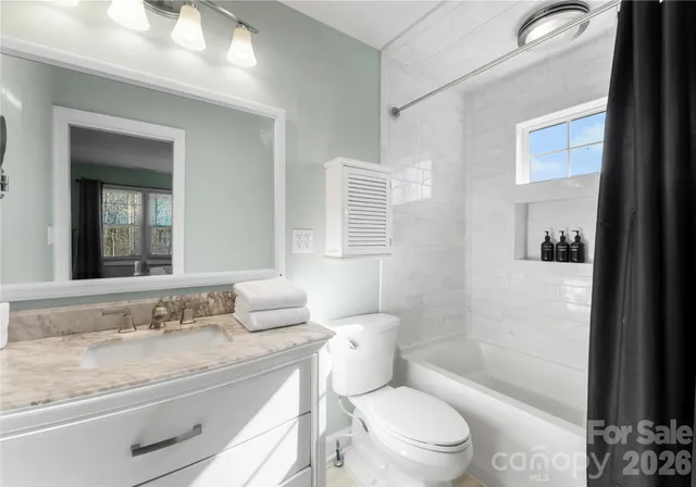 a living room with furniture a rug and a flat screen tv