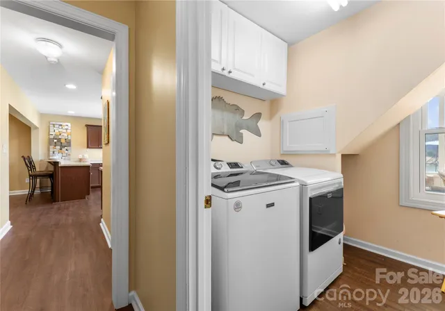 a dining room with furniture a chandelier and wooden floor