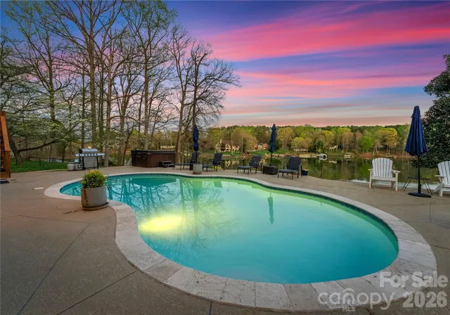 a view of a patio with couches chairs and wooden floor