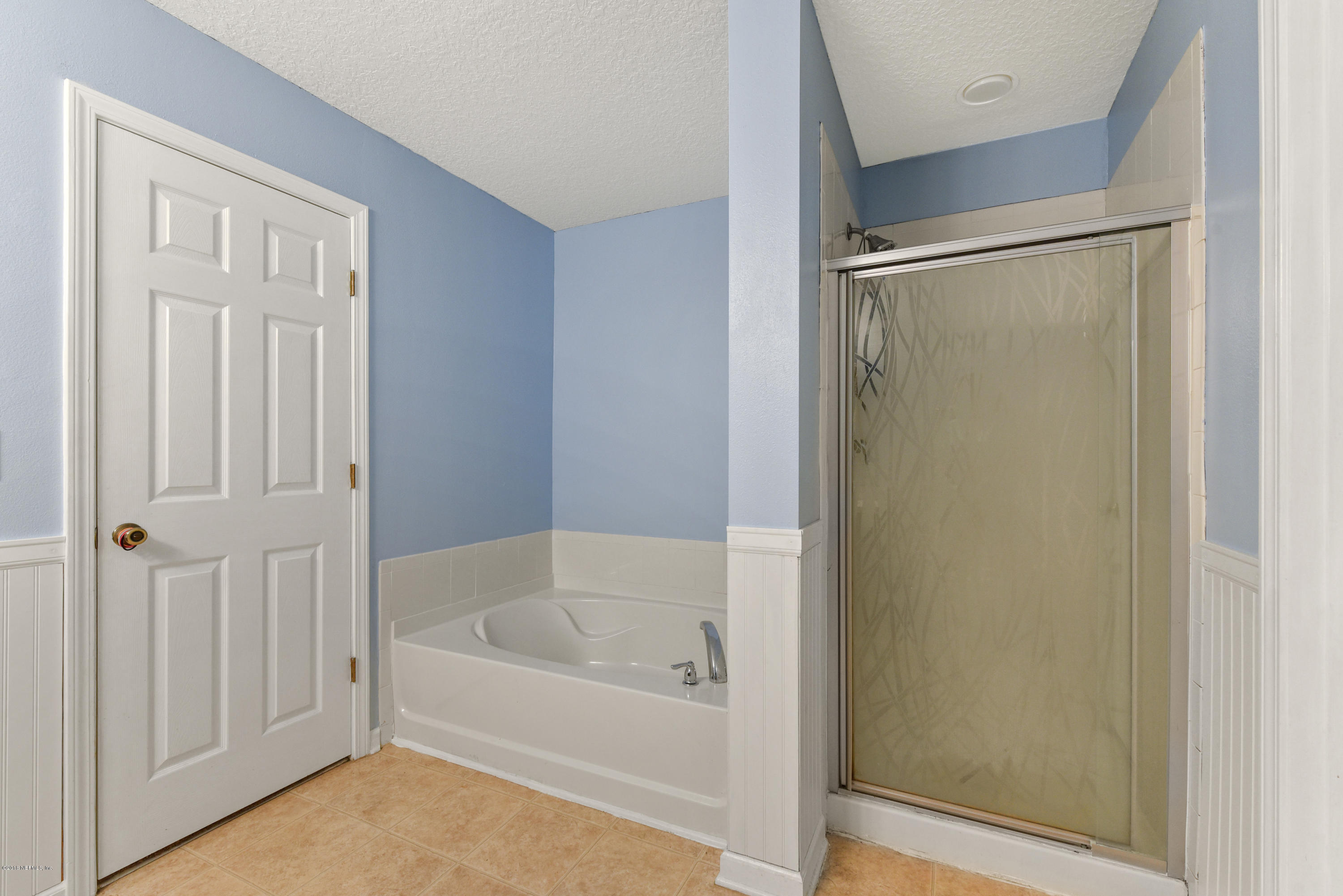 7254 Rampart Ridge Circle South Jacksonville, FL 32244 - Photo 20 of 28 a white bath tub sitting under a bathroom