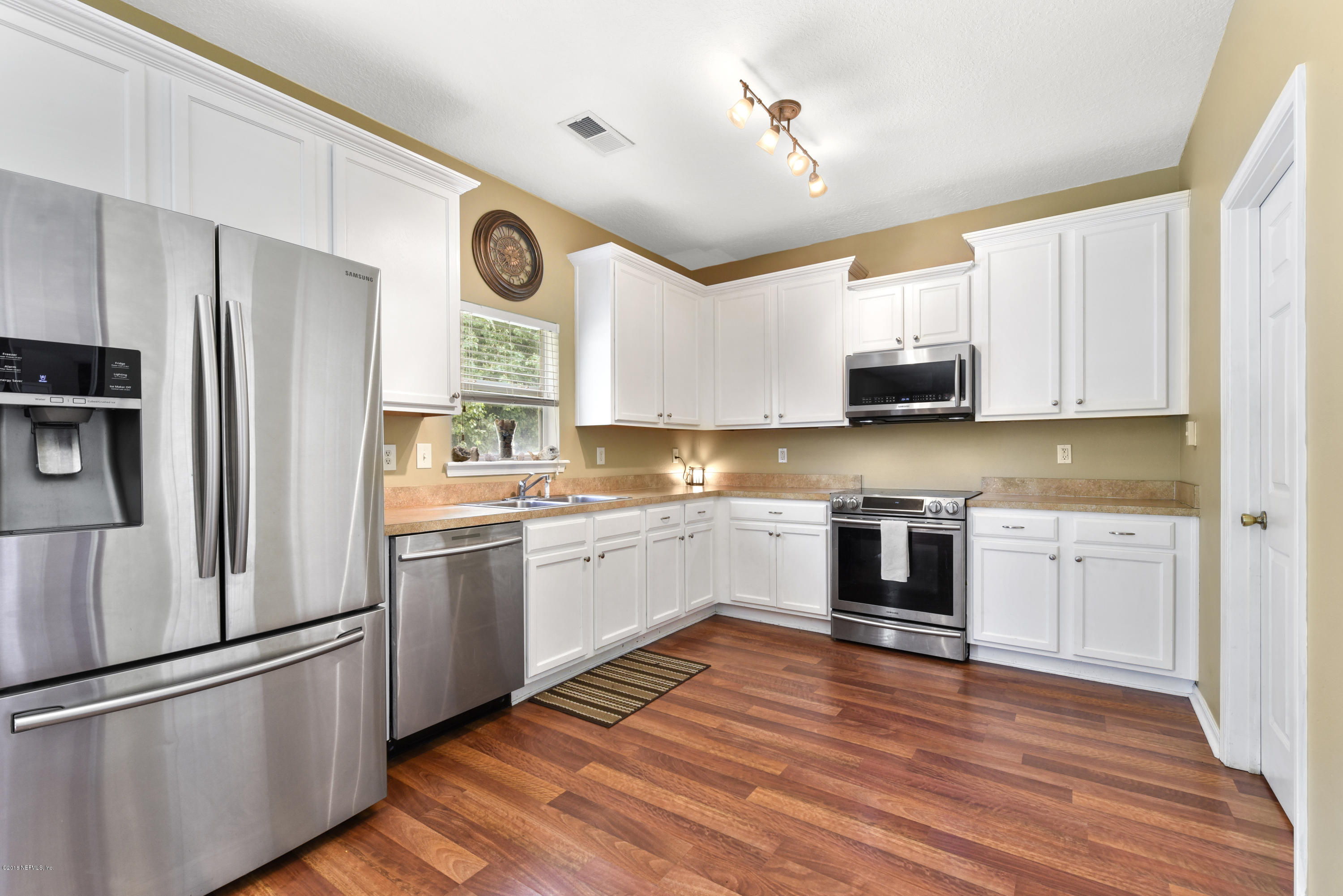 7254 Rampart Ridge Circle South Jacksonville, FL 32244 - Photo 3 of 28 a kitchen with stainless steel appliances granite countertop a refrigerator and a stove top oven