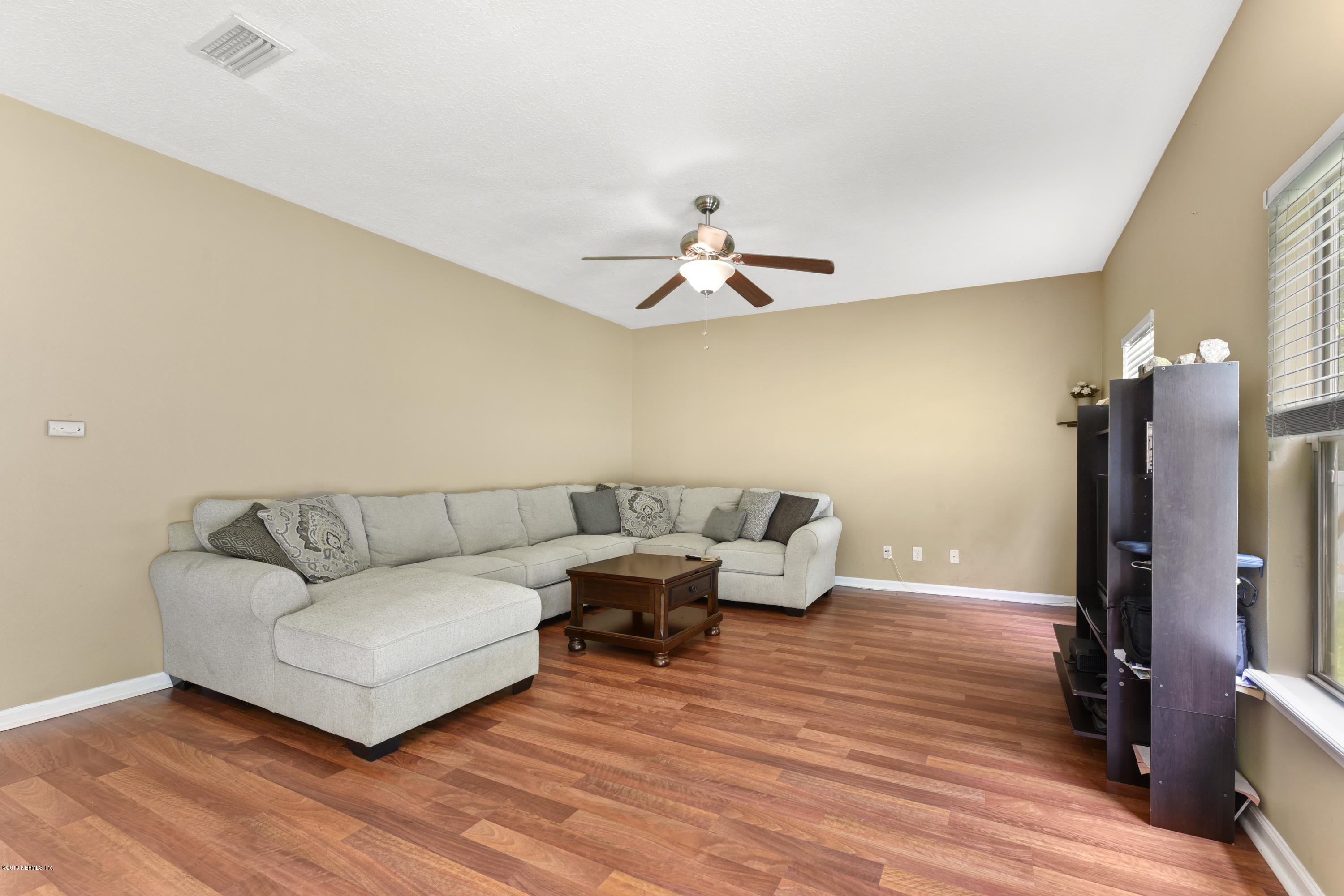 7254 Rampart Ridge Circle South Jacksonville, FL 32244 - Photo 5 of 28 a living room with furniture and a flat screen tv