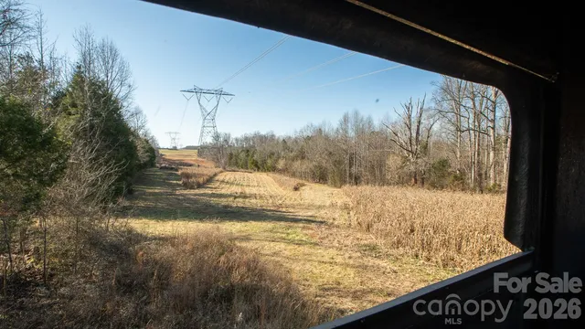 a view of a yard with wooden fence