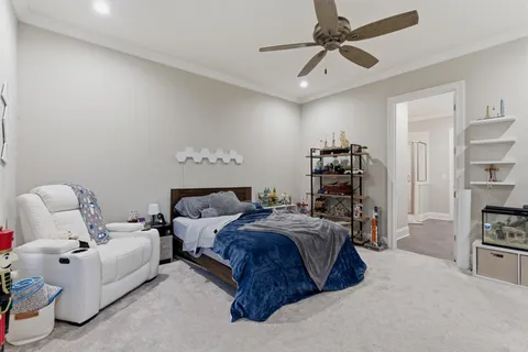 a spacious bedroom with a bed and a chandelier
