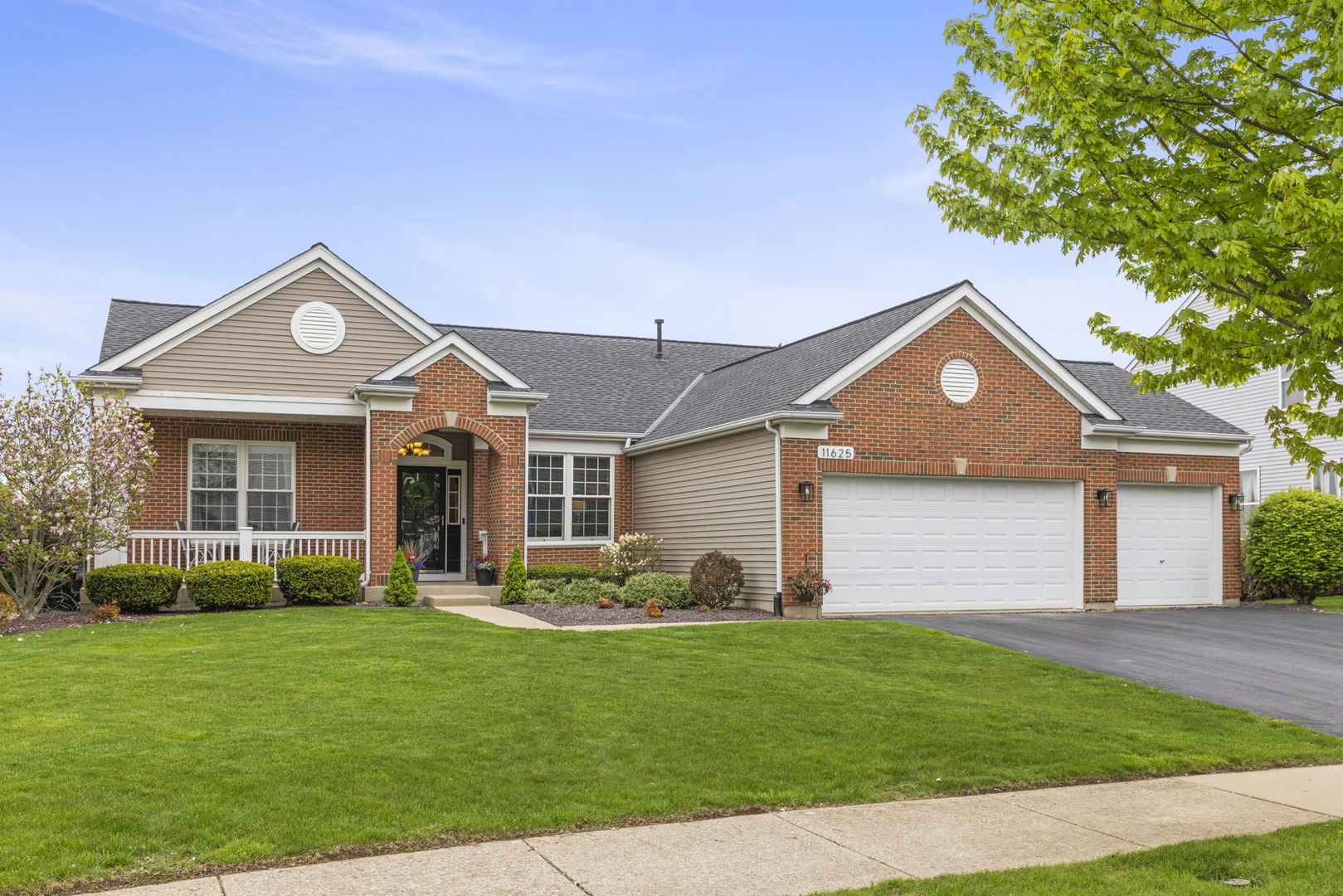 a front view of a house with a yard and garage