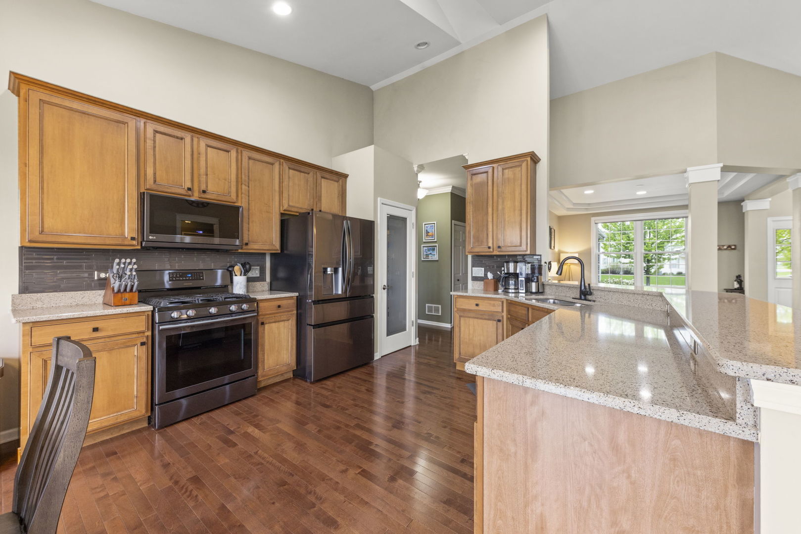 11625 Heritage Meadows Drive Plainfield, IL 60585 - Photo 11 of 40 a kitchen with stainless steel appliances granite countertop a stove a sink dishwasher a refrigerator oven and a oven with wooden floor