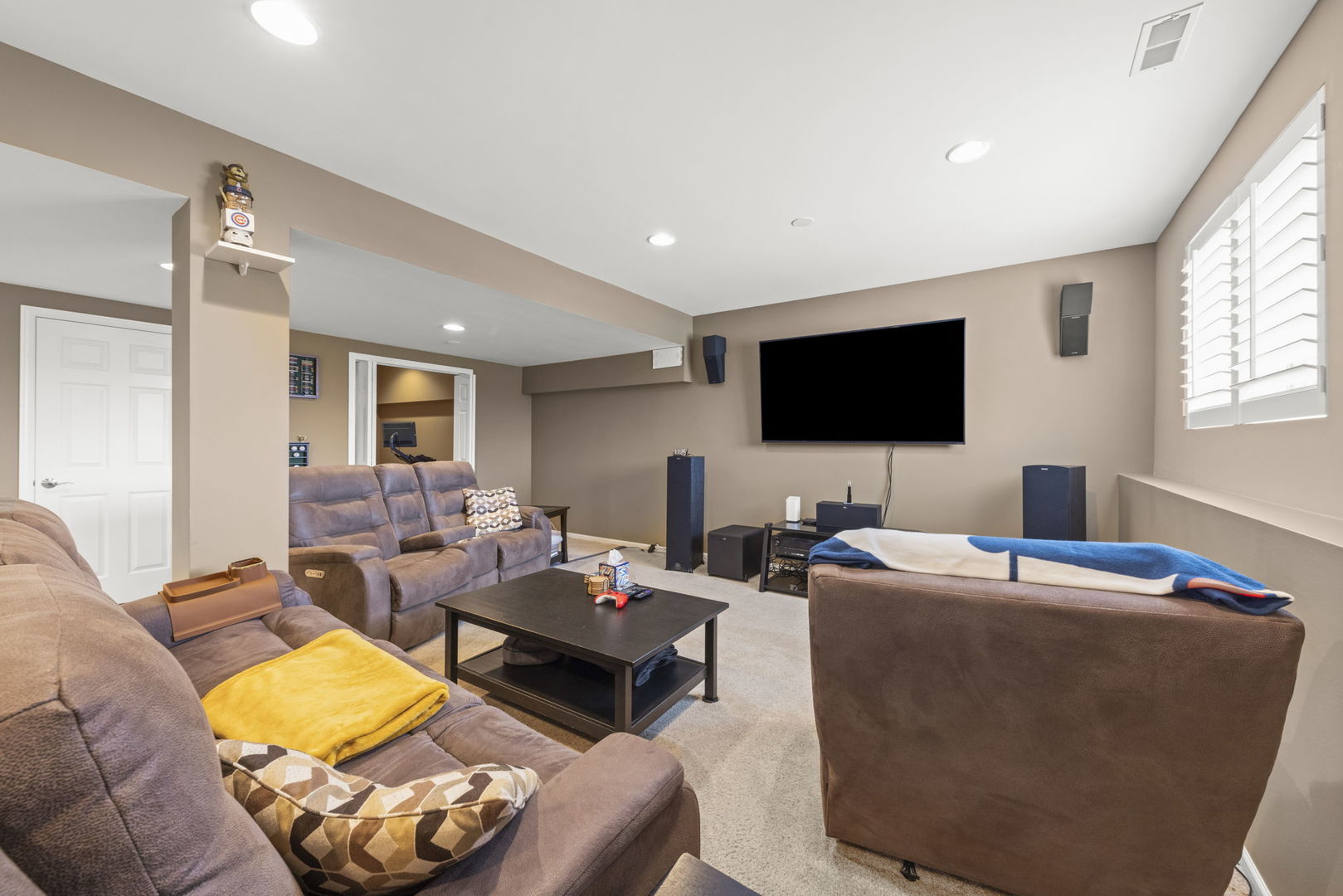 11625 Heritage Meadows Drive Plainfield, IL 60585 - Photo 25 of 40 a living room with furniture and a flat screen tv