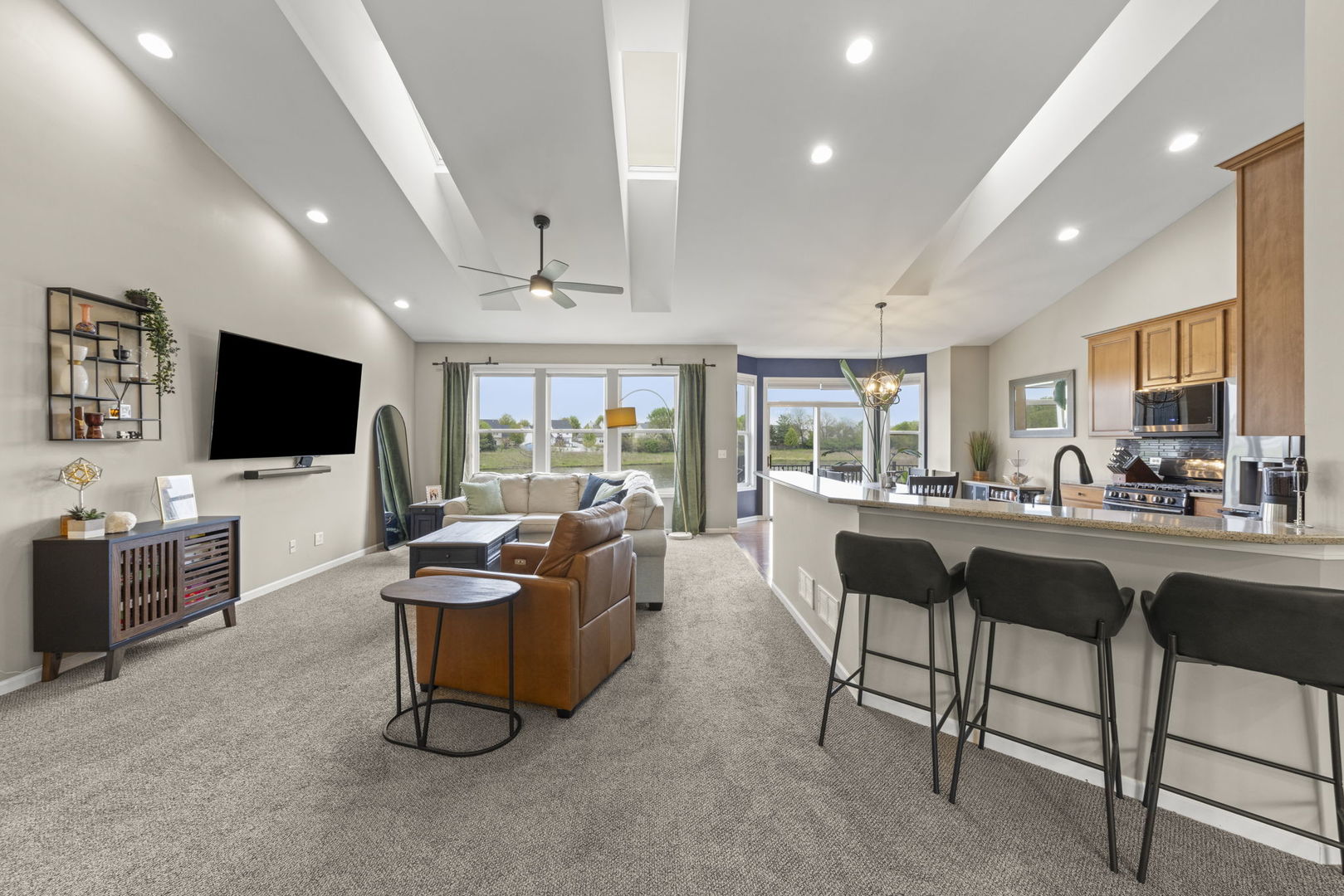 11625 Heritage Meadows Drive Plainfield, IL 60585 - Photo 5 of 40 a living room with furniture and a flat screen tv