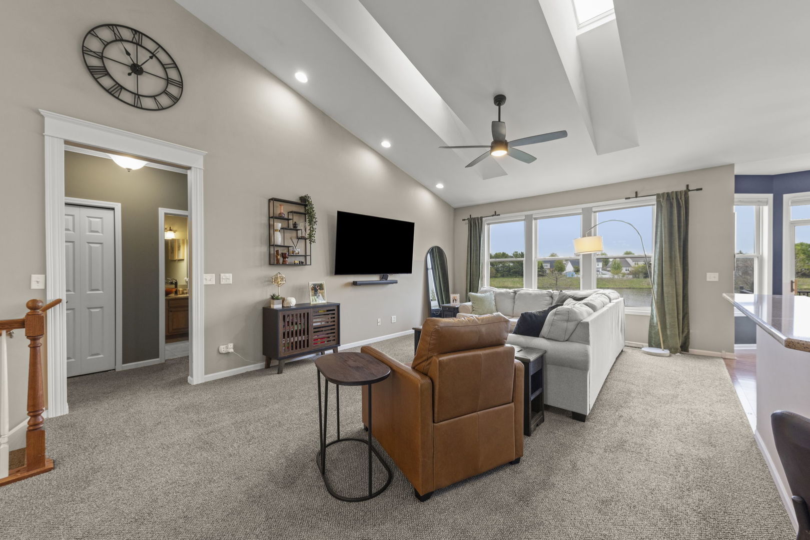11625 Heritage Meadows Drive Plainfield, IL 60585 - Photo 6 of 40 a living room with furniture a flat screen tv and a large window