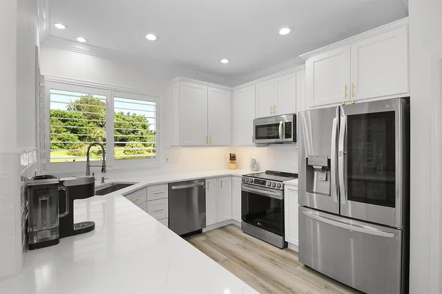 a view of a patio with couches table and chairs and potted plants
