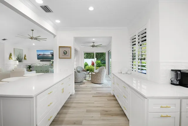 a spacious bedroom with a bed and a chandelier