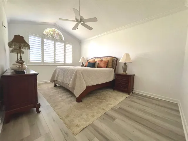 a view of an empty room with a window and wooden cabinets
