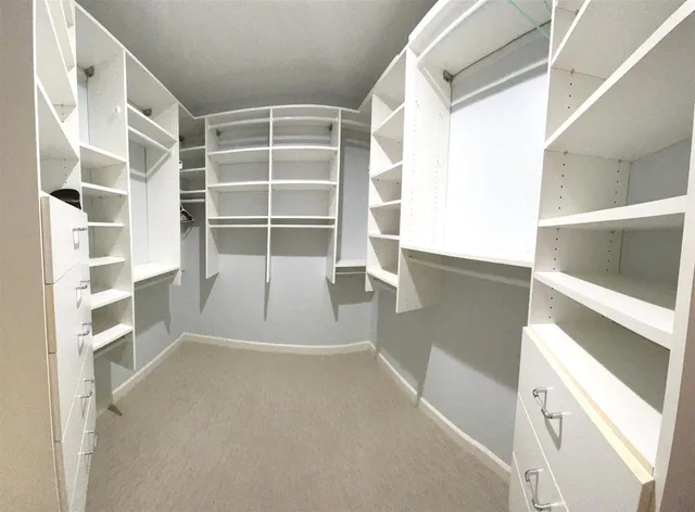 a bathroom with a granite countertop sink vanity mirror and bathtub