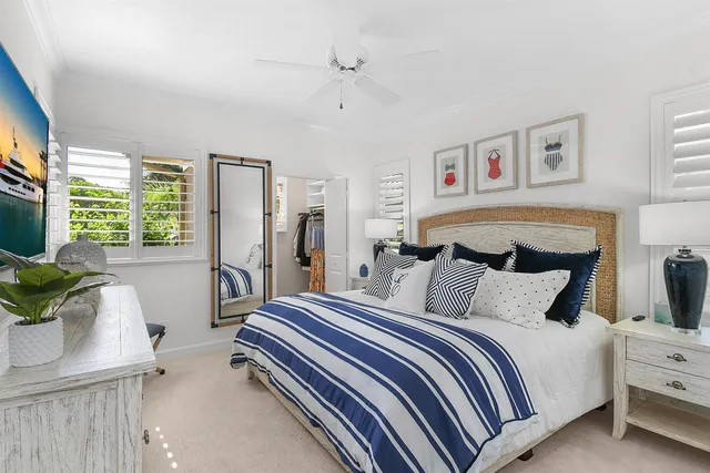 a spacious bedroom with a bed and wooden floor