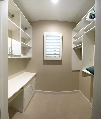 a view of a livingroom with furniture and chandelier fan