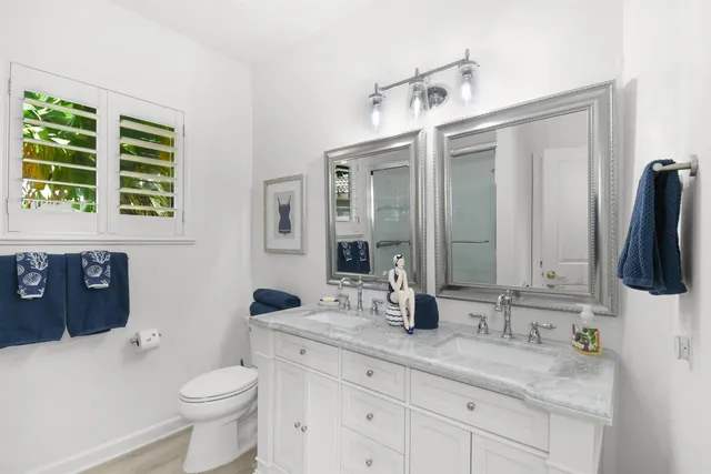 a view of a patio with a table and chairs under an umbrella