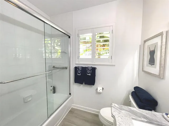 a view of a tables and chairs under an umbrella in backyard