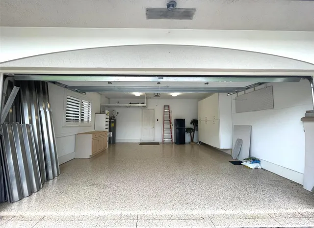 an aerial view of a house with a garden and lake view