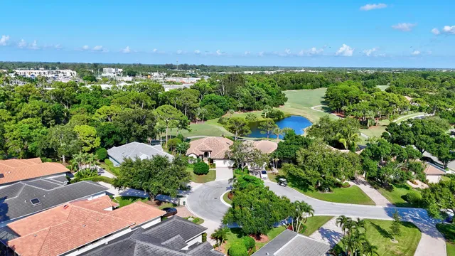 a view of a big house with a big yard and potted plants
