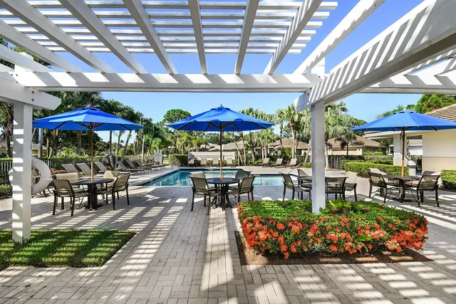a view of a hallway with wooden floor and windows