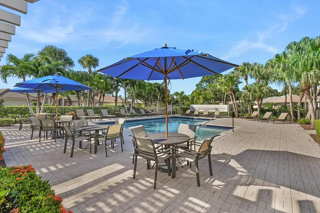 a room with lots of furniture and large windows