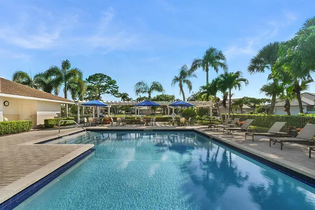 a view of a dining room with furniture large windows and wooden floor