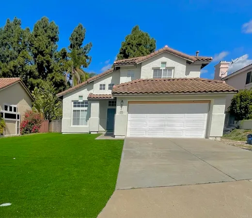 a front view of a house with a garden and yard