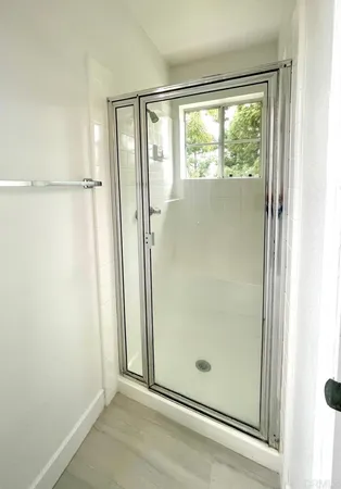 a bathroom with a glass shower door