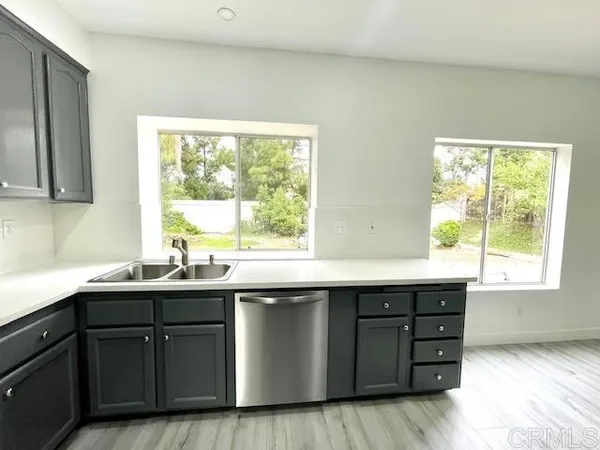 a kitchen with a sink and window