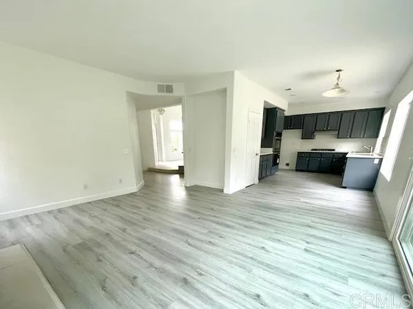 a view of living room with kitchen island furniture and wooden floor