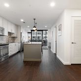 a kitchen with stainless steel appliances a refrigerator sink and microwave