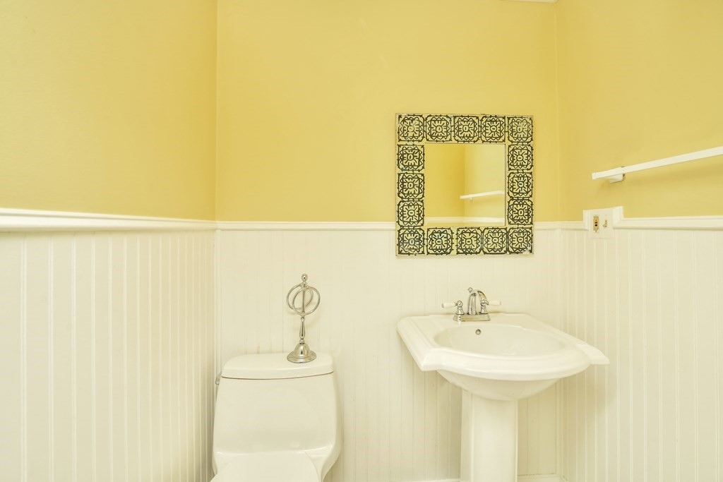 15 Old Farm Road Randolph, MA 02368 - Photo 15 of 22 a bathroom with a sink a mirror and a toilet