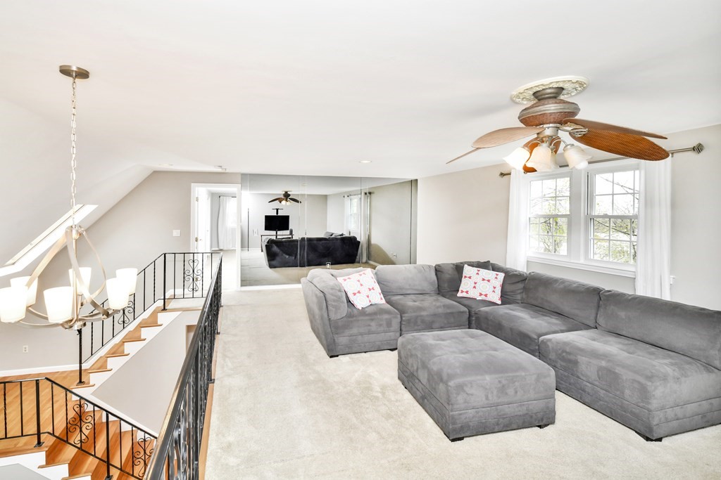 15 Old Farm Road Randolph, MA 02368 - Photo 9 of 22 a living room with couches a fireplace and next to a window