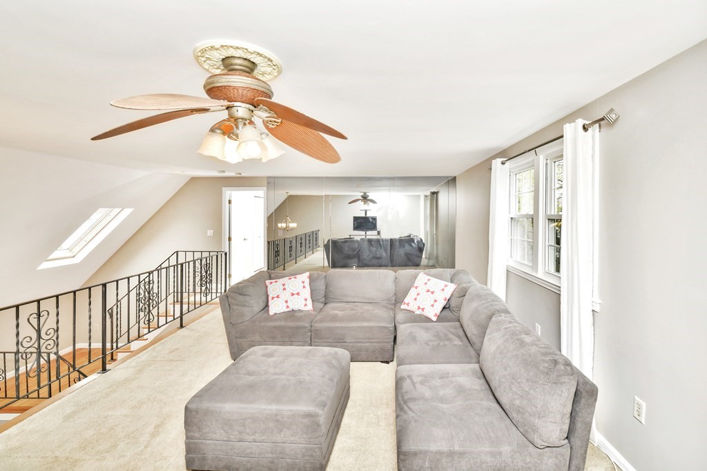 15 Old Farm Road Randolph, MA 02368 - Photo 10 of 22 a living room with furniture a chandelier and a window