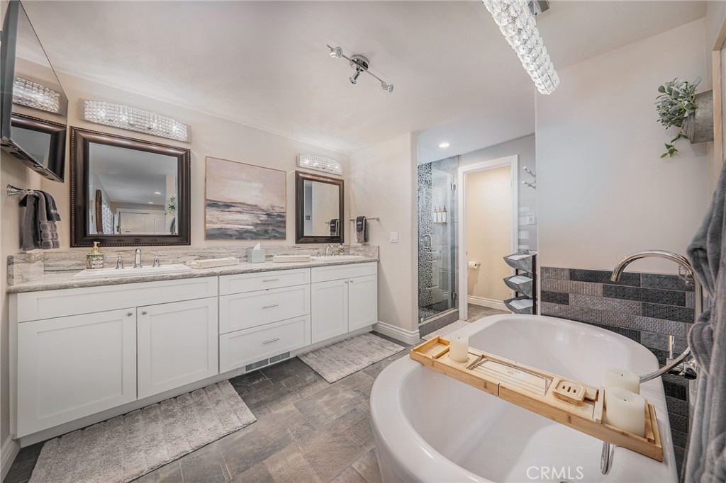 27550 North Bay Road Lake Arrowhead, CA 92352 - Photo 23 of 53 a spacious bathroom with a granite countertop sink and a mirror