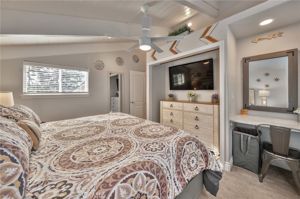 27550 North Bay Road Lake Arrowhead, CA 92352 - Photo 33 of 53 a bedroom with a large bed a flat tv screen and a dresser