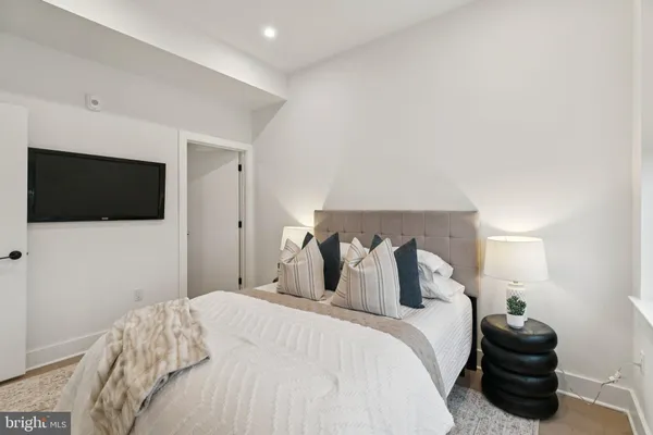 a bedroom with a bed and a flat screen tv