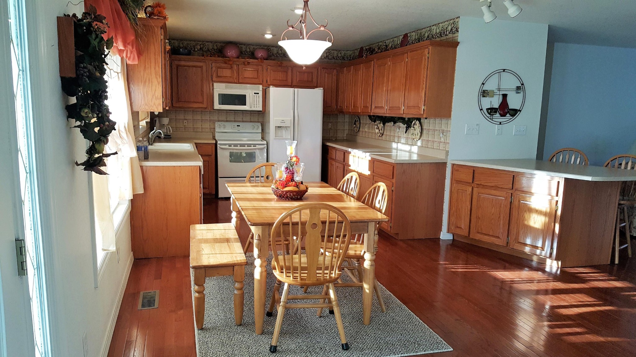 1296 Kingtown Road Winfield, TN 37892 - Photo 14 of 36 a dining room with furniture a fireplace and wooden floor