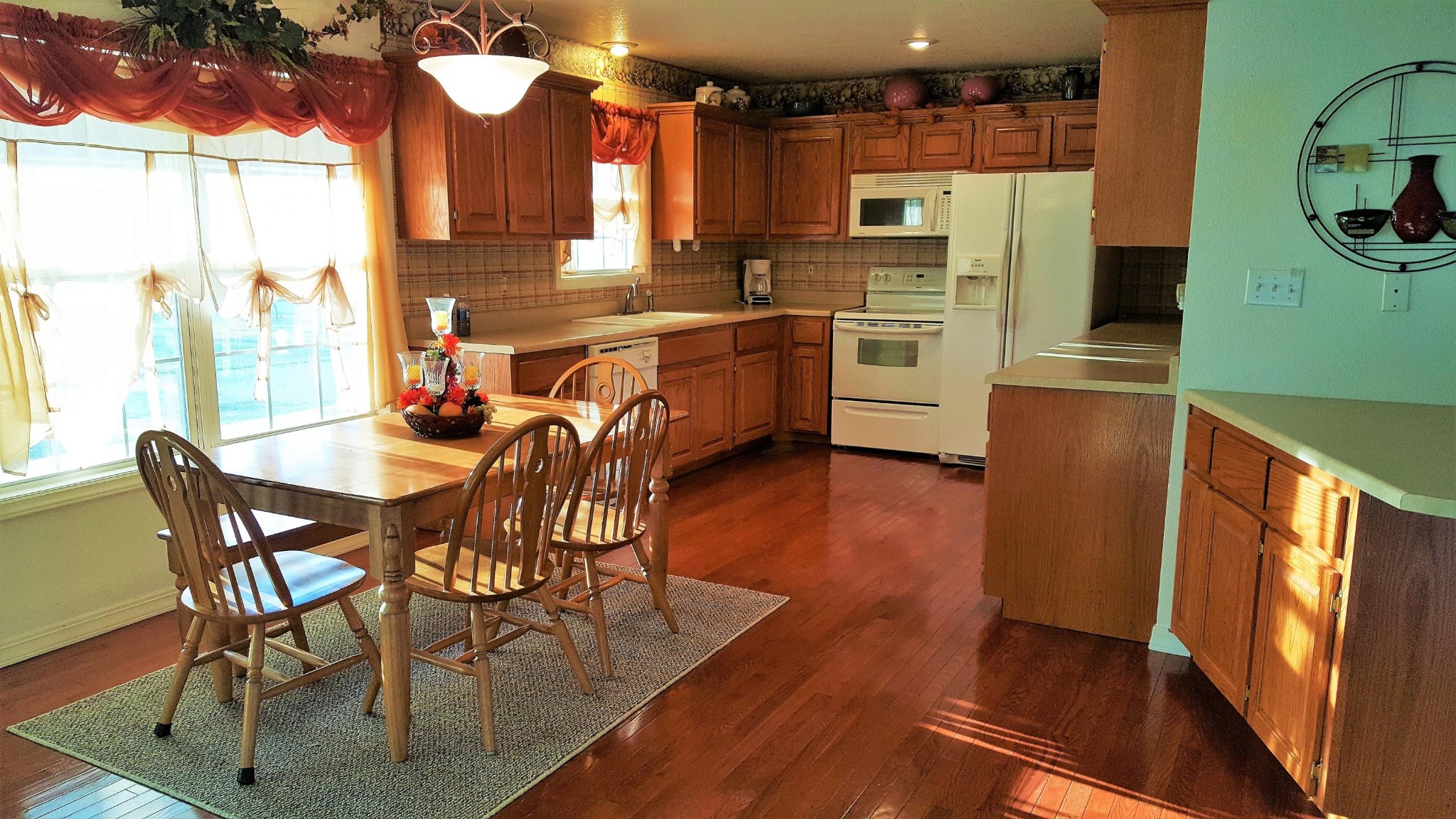 1296 Kingtown Road Winfield, TN 37892 - Photo 17 of 36 a kitchen with stainless steel appliances a dining table chairs and a refrigerator