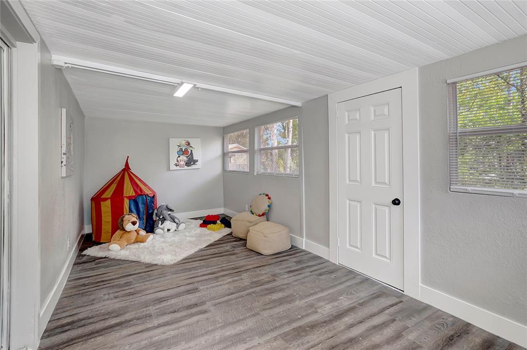 16133 Ravendale Drive Tampa, FL 33618 - Photo 20 of 46 a room with wooden floor and workspace