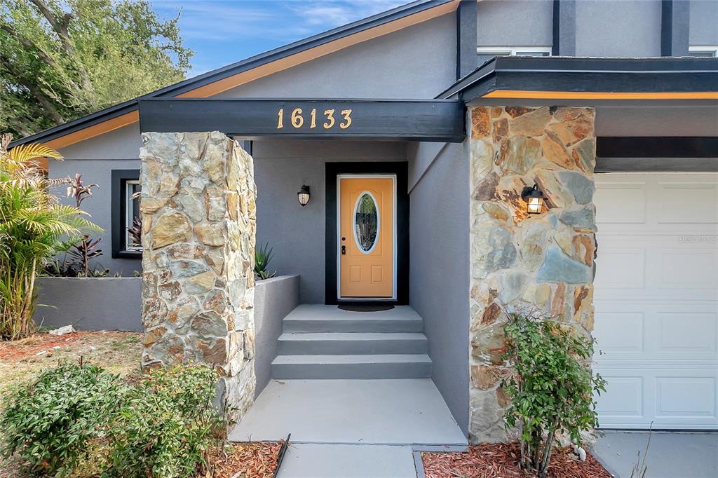 16133 Ravendale Drive Tampa, FL 33618 - Photo 2 of 46 a front view of a house with a garden