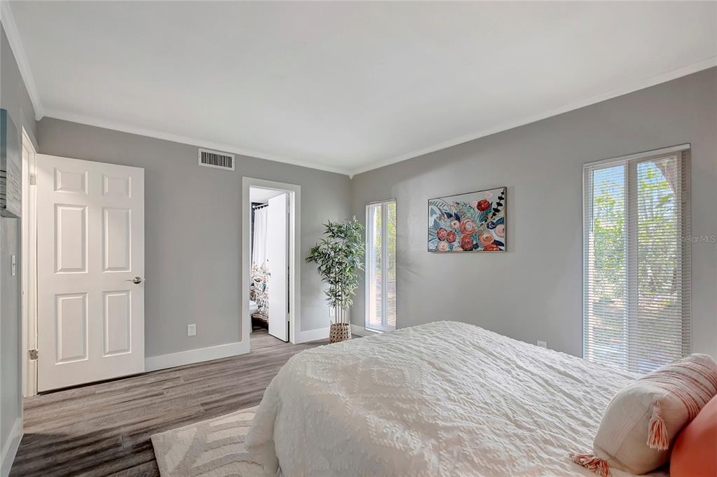 16133 Ravendale Drive Tampa, FL 33618 - Photo 24 of 46 a bedroom with a bed and wooden floor