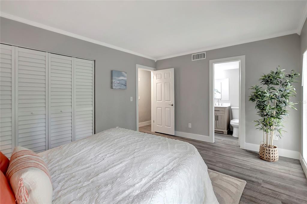 16133 Ravendale Drive Tampa, FL 33618 - Photo 25 of 46 a bedroom with a bed and a potted plant