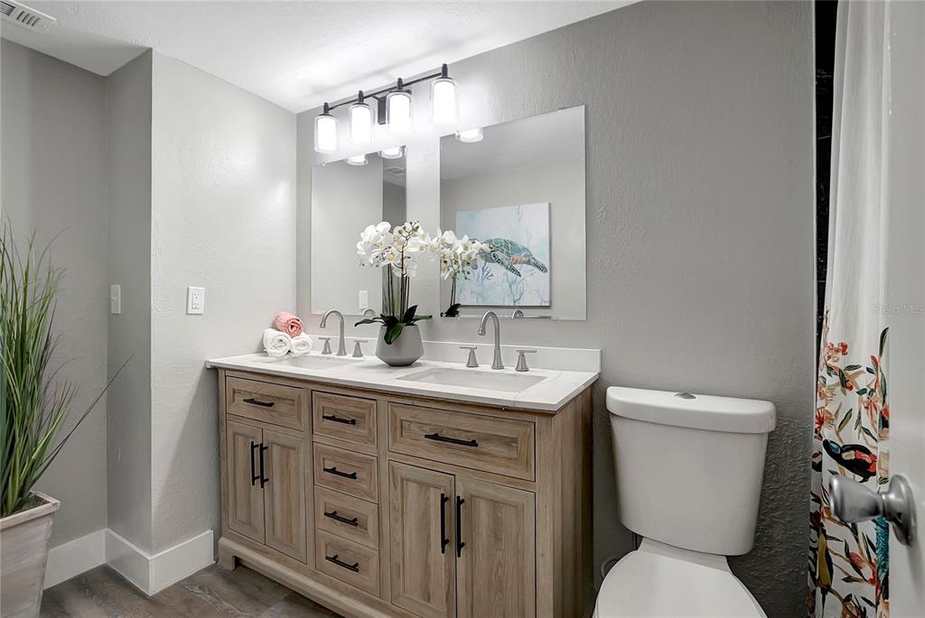 16133 Ravendale Drive Tampa, FL 33618 - Photo 26 of 46 a bathroom with a toilet sink and mirror