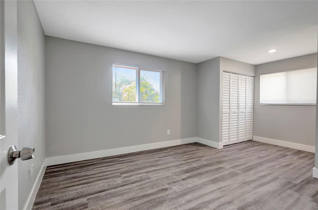 16133 Ravendale Drive Tampa, FL 33618 - Photo 36 of 46 an empty room with wooden floor and windows